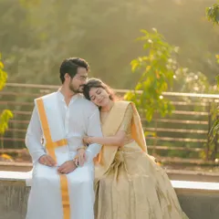 A tender moment between a couple in traditional South Indian attire, captured in soft, golden sunlight. This photo radiates warmth, peace, and affection.