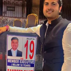 Standing next to my campaign poster for Member Executive of the DBA. I ran on a platform of support and betterment for lawyers, especially those in their early years of practice.