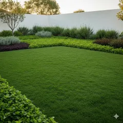 A close-up of a pristine lawn bordered by a variety of shrubs and groundcover plants. We use layered planting to create texture and color, ensuring the garden looks full and vibrant.