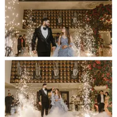 A fairytale entrance for a modern couple. Surrounded by sparklers and a cloud of smoke, this couple makes their grand entrance, ready to celebrate their love. This shot captures the glamour and excitement of a reception party.