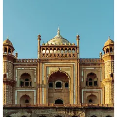 The grand facade of Safdarjung's Tomb against a clear blue sky, showcasing its impressive scale and symmetrical design.
