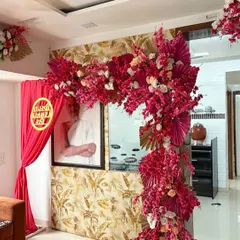 A vibrant and auspicious setup for a Jain Tapasvi ceremony. We created this stunning floral arch using bold pink artificial blossoms and golden palm leaves to frame the sacred space with color and reverence.