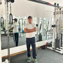 In the gym at Noida Sector 99. You can see my "COACH" shirt, a symbol of my dedication to helping you achieve your goals.