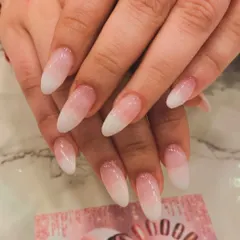 A timeless classic, the baby boomer ombre. This elegant design features a seamless gradient from a soft pink base to a clean white tip on long almond-shaped extensions, perfect for any occasion.