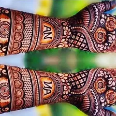 This engagement mehendi features the couple's initials in a beautiful circular frame on each hand.