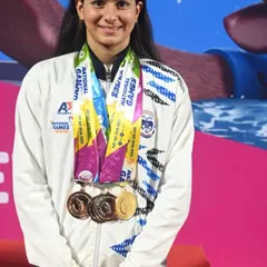 We train athletes to win. This is one of our national-level swimmers, showcasing the medals earned through relentless dedication and our expert coaching at the National Games.