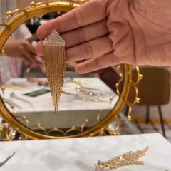A close-up of our rhinestone-style tassel earrings in a gold finish. These were part of a recent giveaway and are perfect for both western and traditional outfits.