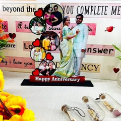 A beautiful anniversary gift, this tabletop display features a full-size cutout of the couple alongside a cascade of smaller photos from their journey together.