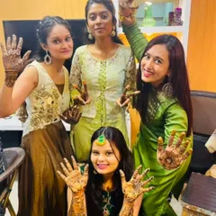 A happy bride with her friends, all showing off their mehandi. My team and I can handle bookings for the bride and all her guests.