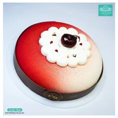 A modern take on a classic, our Black Forest Revisited cake. This entremet features a beautiful red and white velvet finish, with a fresh cherry and cream topping.