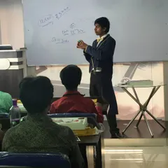 I believe in breaking things down step-by-step. Here, I'm demonstrating a sleight of hand technique to the class, ensuring everyone understands the method before they try it.
