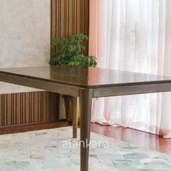 A full view of the Zircon dining table, showcasing its clean lines and beautifully finished Teak wood surface. It’s a timeless piece designed to host gatherings for years to come.
