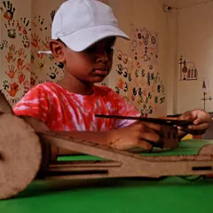 A young engineer assembles his rubber powered car. This project is a fantastic introduction to mechanical engineering and the principles of stored energy.