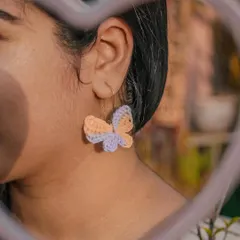 This is the vibe. A close-up of my handmade Titli (butterfly) earrings, crafted from 100% cotton yarn so they're super lightweight. They add that perfect whimsical touch to any look.
