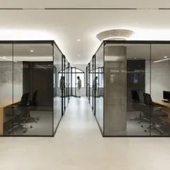 A view of the glass-walled offices at the Sushee headquarters, designed to promote transparency and a sense of calm. The clean lines and uncluttered aesthetic reflect our belief that a workplace should be an orderly environment that supports focus and collaboration.