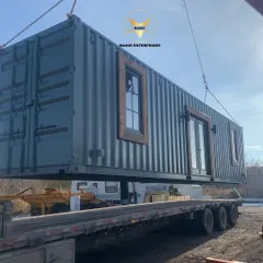 We handle the entire logistics process, from factory to your site. Here, a custom-built container home is carefully loaded for delivery, showcasing the robust and portable nature of our prefabricated structures.