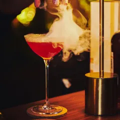 A unique creation for a private party. This martini combines the flavors of blood orange and Himalayan rhododendron, finished with a dramatic swirl of smoke.