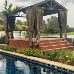 We constructed this stunning poolside gazebo at Prestige Golfshire, Bangalore. It features a raised WPC deck and elegant curtains, creating a luxurious and shaded lounge area perfect for enjoying the tranquil water views.