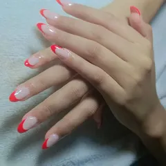 You can never go wrong with a classic red French manicure. This elegant design features sharp, almond-shaped nails with a clean nude base and vibrant red tips.