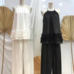 Here is another take on the co-ord set, featuring a flowy halter-neck top with a ruffled hem and matching wide-leg pants. It’s a versatile outfit that can be dressed up or down, and I create it in both black and white for timeless appeal.