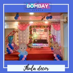 A classic and elegant Dohale Jevan setup. The beautifully decorated jhula is the centerpiece, complemented by a floral moon, soft drapery, and cute baby cutouts for a picture-perfect event.