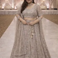 A full-length view of this stunning plus-size designer lehenga. The matching embroidered blouse and sheer dupatta complete a look that is perfect for a wedding guest or bridesmaid.