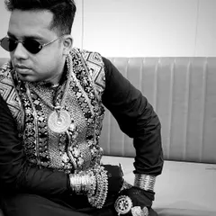 A black and white shot that highlights the details of my accessories. The layered necklaces, bracelets, and rings are a key part of my stage persona.