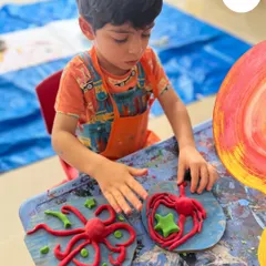 It’s not just about paint. Here, a young artist concentrates on sculpting with clay, developing fine motor skills and bringing his imagination into three dimensions. We provide a variety of materials to let children explore different forms of texture and expression.