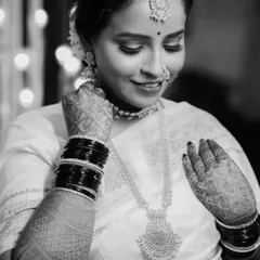 A timeless black and white bridal portrait. This image of Sayali focuses on her serene expression and the beautiful details of her jewelry and mehndi, creating a classic and elegant photograph.