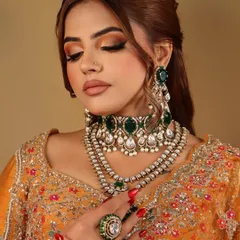 An eyes-closed shot to show the beautiful half-cut crease and the blend of marigold and amber hues on the eyelids.