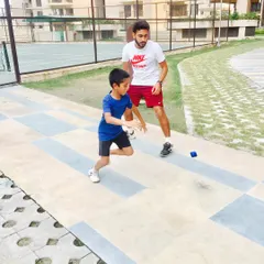 Quick reflexes are non-negotiable in tennis. Here, a young player works on his reaction time with a specialized reaction ball, a drill we use to improve hand-eye coordination and speed.