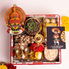 An overhead view of the fully assembled 'Ponnonam' luxury Onam hamper. This shot highlights the careful arrangement of each item, from the Kathakali decor to the jarred traditional snacks and the Mahabali greeting card.