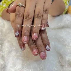 Another view of the 3D floral art on natural nails. The small, sculpted flowers add a beautiful, tactile element to the manicure, making it truly special.