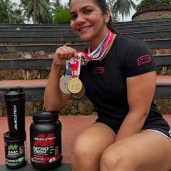 Posing with my medals and the supplements that powered my performance. I placed second overall and first in the deadlift with a new national record at the 2025 championship in Kozhikode.