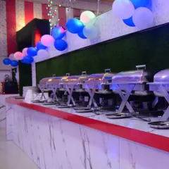 I also handle decorations for the catering and buffet area. Here you can see a clean setup with a marble-finish counter and simple balloon decor.