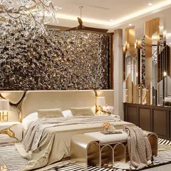 Black and gold are the new statement of luxury. This bedroom features a stunning textured headboard, a gold-mirrored partition, and a bold black-and-white rug to create a space that is both dramatic and elegant.
