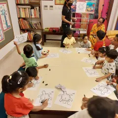 I believe in building foundational skills early. Here, I'm guiding my toddler class (ages 3 to 5) through a drawing exercise to develop their control and observation.