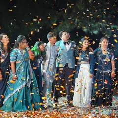 The grand finale of a sangeet performance, with the whole family coming together on stage under a shower of confetti. We love creating these big, inclusive moments that become a core memory of the wedding.