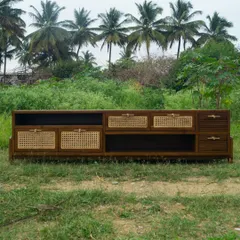 The Ballygunge TV unit, custom-designed to our client's requirements. This large piece features a mix of rattan, fluted wood, and open shelves, creating a functional and visually interesting focal point for the living room.