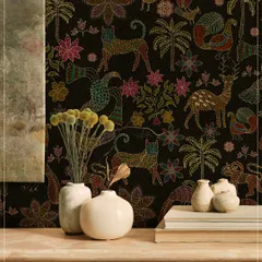The Sundarban Jaal wallpaper, with its colorful, stitched-style animals and plants against a black background, creates a playful yet sophisticated feature wall. It pairs beautifully with neutral, rustic decor.