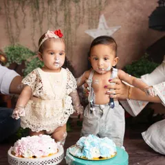 Double the trouble, double the fun. A half birthday cake smash for twins is twice as messy and twice as cute.