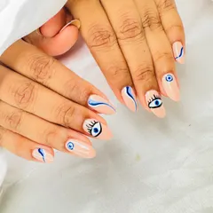 Keep the bad vibes away with this trendy evil eye nail art. I hand-paint each design on a clean nude base, combining detailed eye art with modern abstract blue swirls for a unique, protective style.