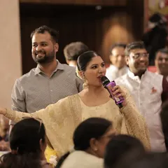 Walking through the crowd, engaging with guests directly. This personal touch helps create a warm and friendly atmosphere.