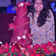 A proud moment standing next to one of my largest creations, a magnificent, multi-tiered red wedding cake, all set up and ready for the celebration.