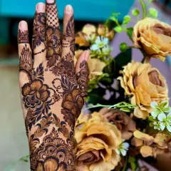 A close-up of a floral design, showing the beautiful details of the flowers and leaves against a matching floral background.
