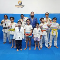 A group photo of our junior Judo team with their well-earned medals. Seeing their pride and sense of accomplishment is the greatest reward for a coach.