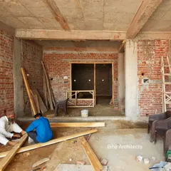 This image captures our carpenters at work, crafting wooden frames for doors and windows on site. We manage all aspects of site work to ensure that every element, from the structural to the decorative, is executed to our exacting standards.