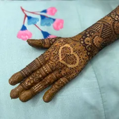 A simple yet beautiful heart motif left as negative space on the back of the hand. This is a popular request for brides who want a touch of romance in their design.