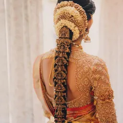 Another angle of this stunning traditional braid, showing the intricate detail of the gold hair accessories and the neatness of the styling.
