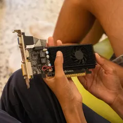 A student holds a graphics card, learning about its function and how it fits into the motherboard. We break down each component so kids understand the role it plays in the overall system.